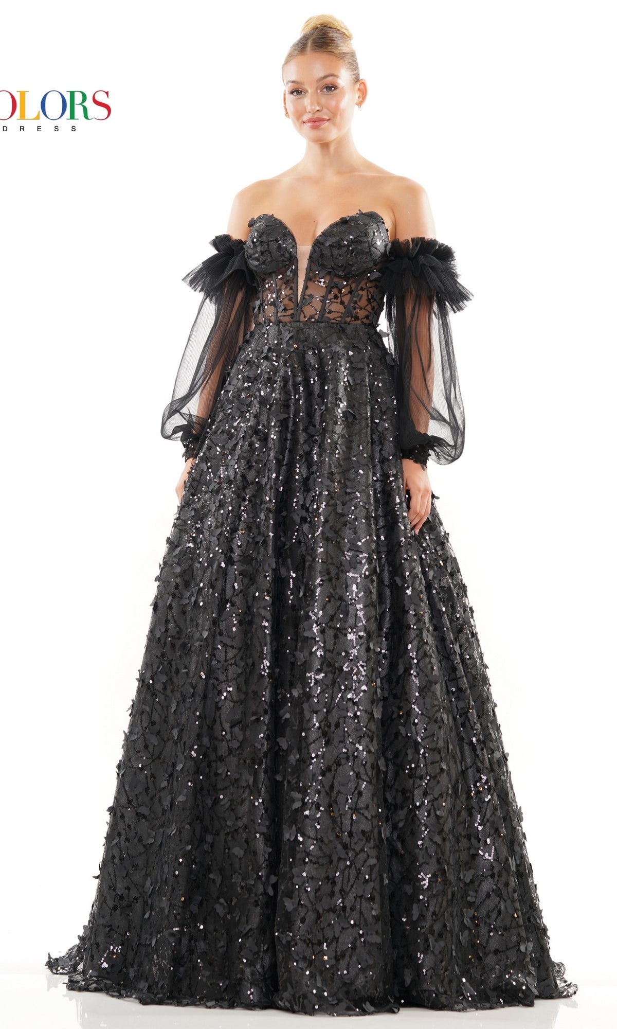A woman wears the 3D Butterfly Formal Ball Gown 3226 with removable sheer sleeves, featuring a floor-length black design, sequin embellishments, and a fitted semi-transparent bodice.